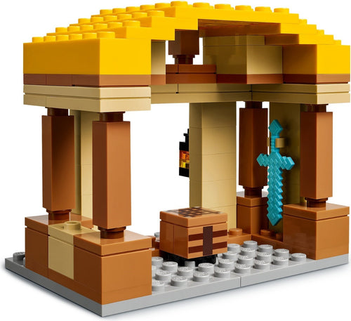 LEGO structure with yellow roof, brown pillars, and blue decorative element on a white background