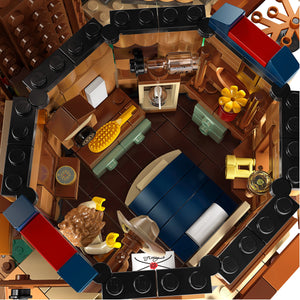 Top-down view of a detailed LEGO model of a living room with furniture and decor.
