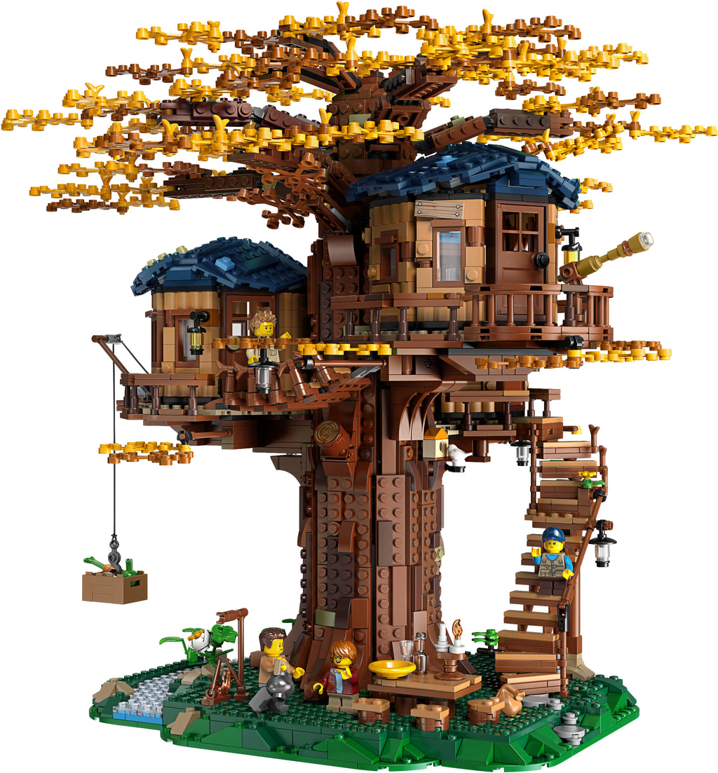 Toy treehouse with detailed architecture and small figures on a white background