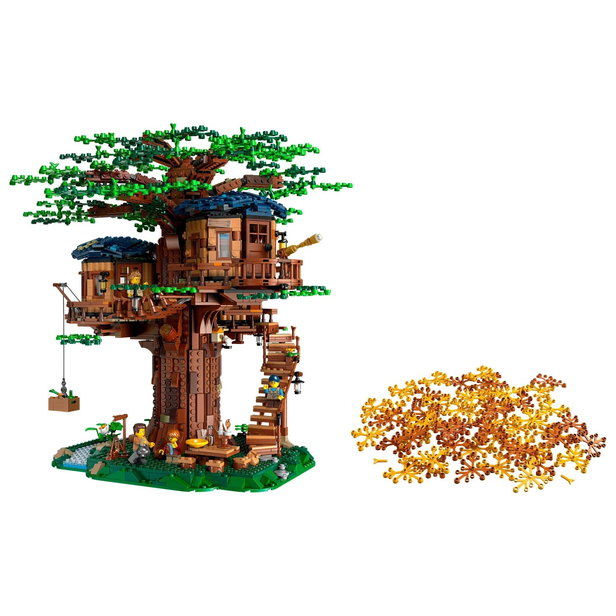 Toy treehouse model with greenery and a small pile of gold coins on a white background