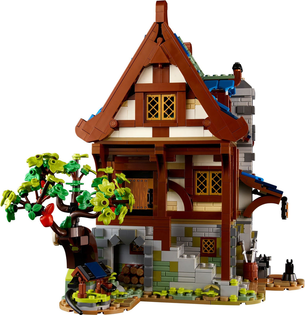LEGO model of a quaint house with a tree and small garden on a white background