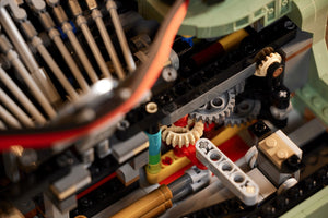 Close-up of a LEGO model with gears and mechanical components.