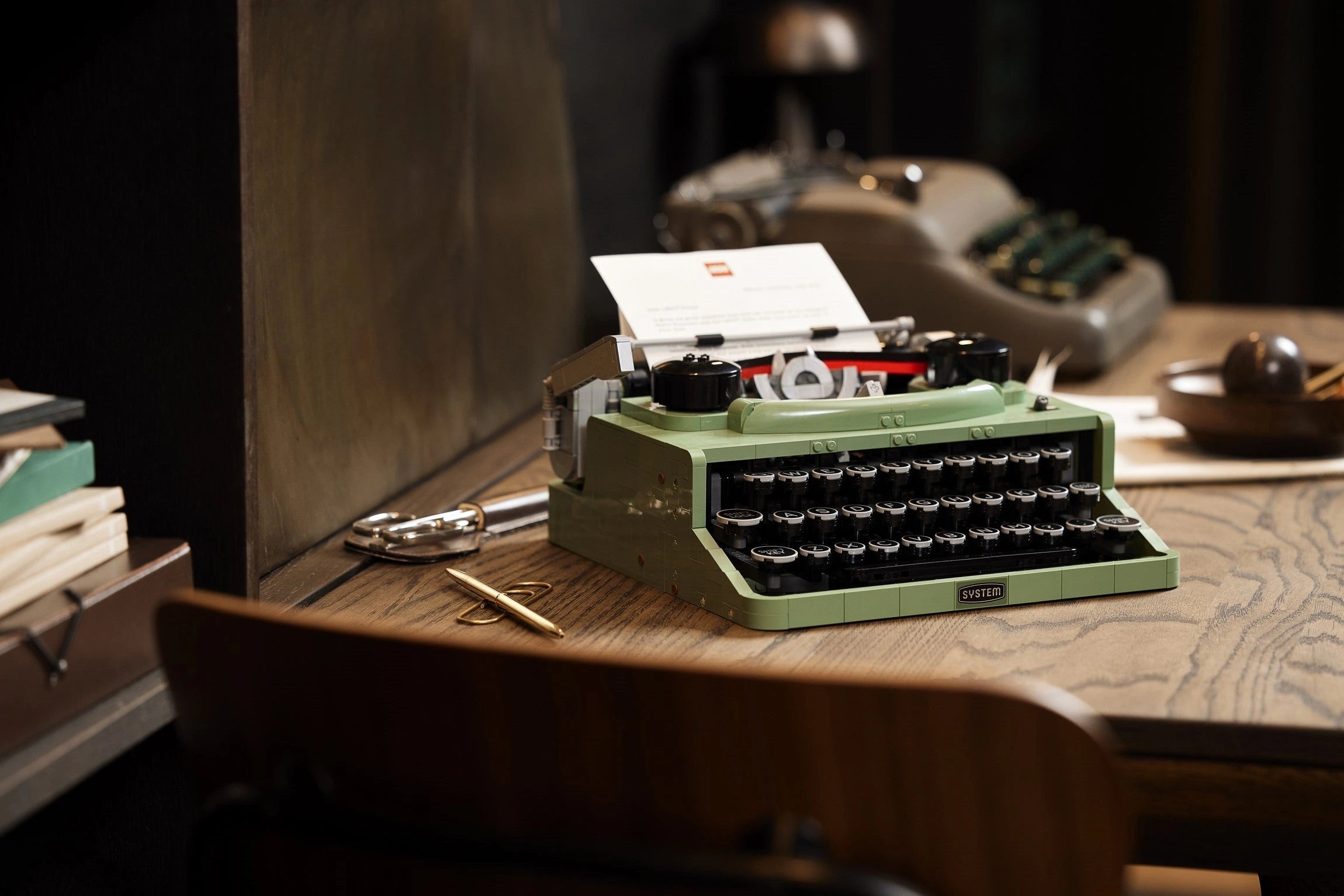 Vintage green typewriter on a wooden desk with a blurred background