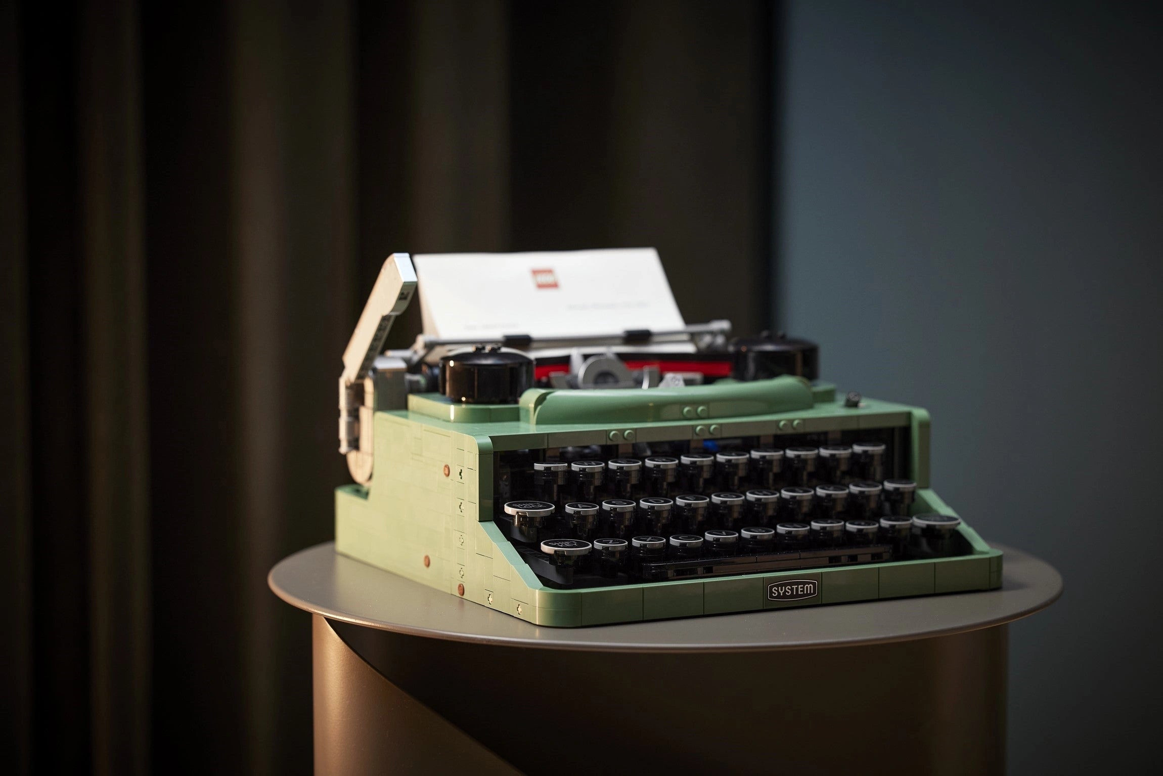 Green typewriter on a dark background