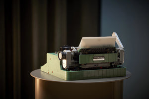 Model of a typewriter on a dark background