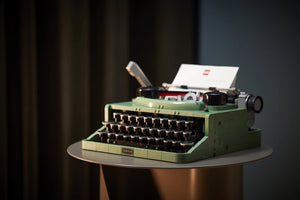 Green typewriter on a dark background