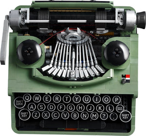 Green typewriter model with intricate mechanical details on a white background