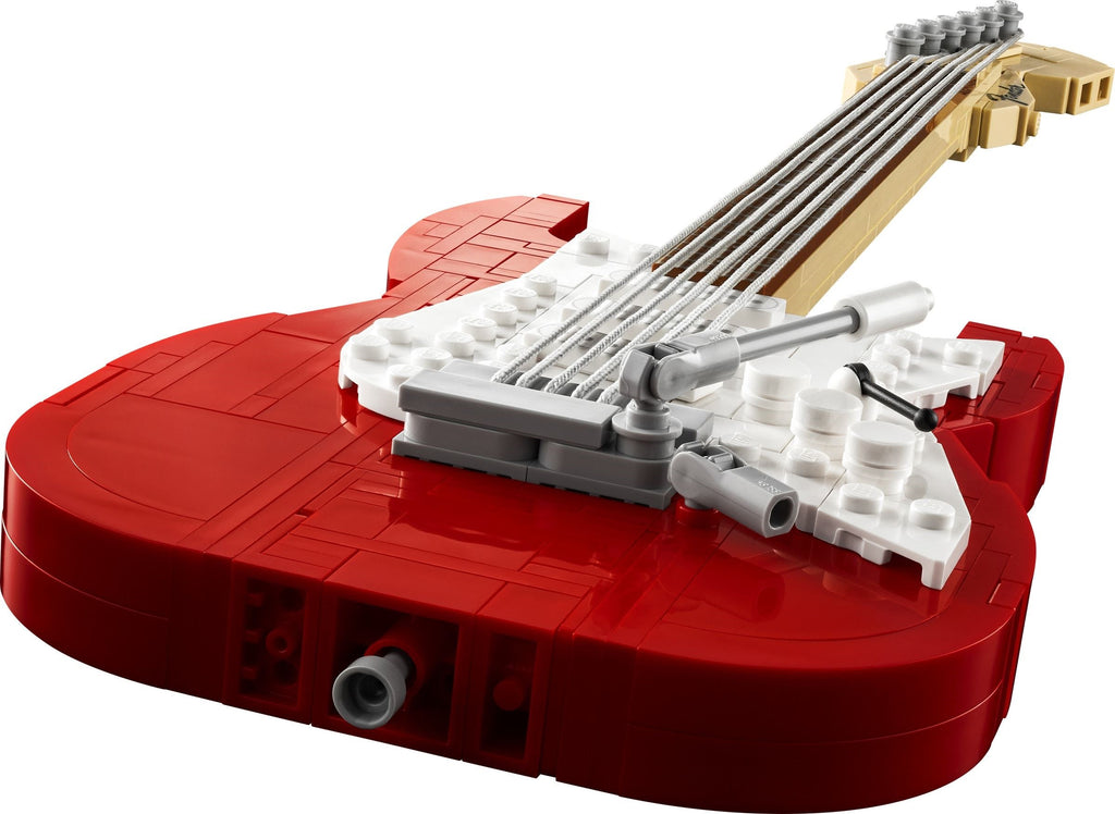 Red guitar model made of interlocking bricks on a white background