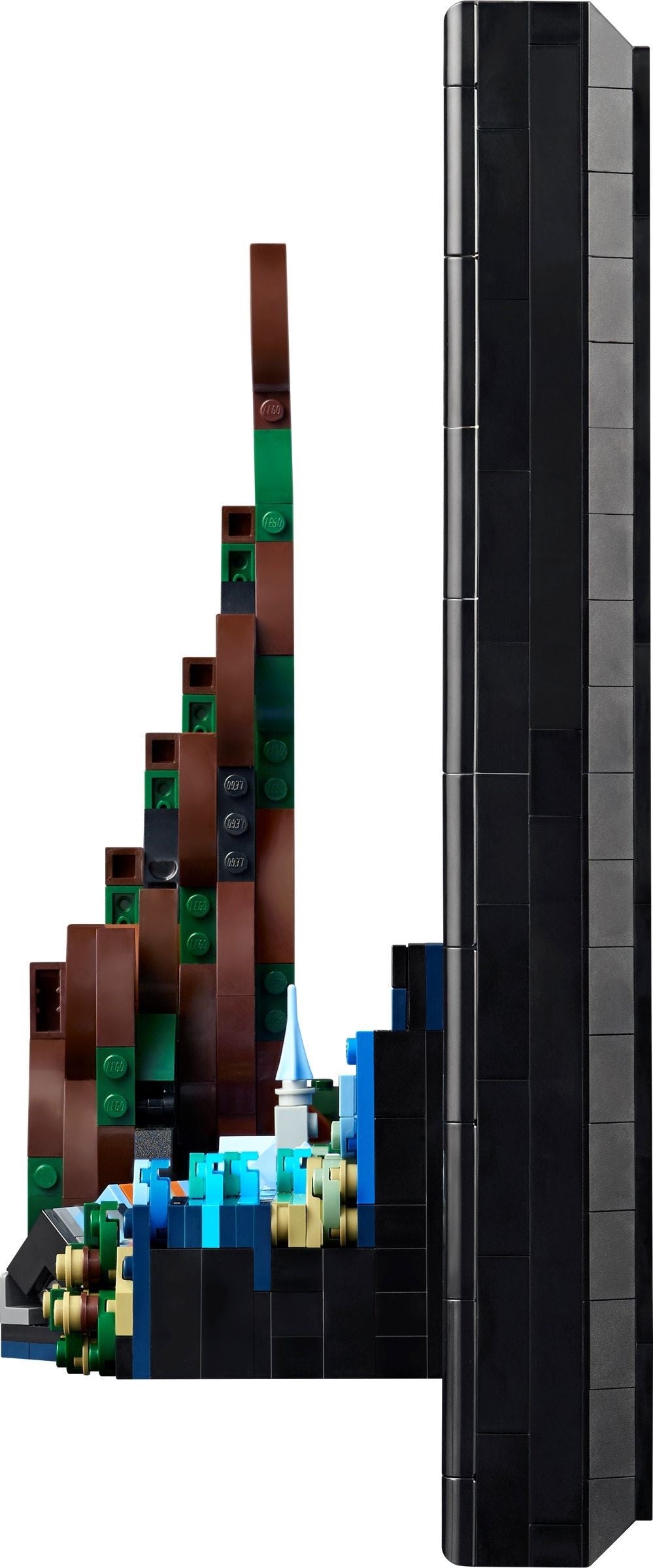 LEGO model of a mountain with a castle on top, leaning against a black wall.