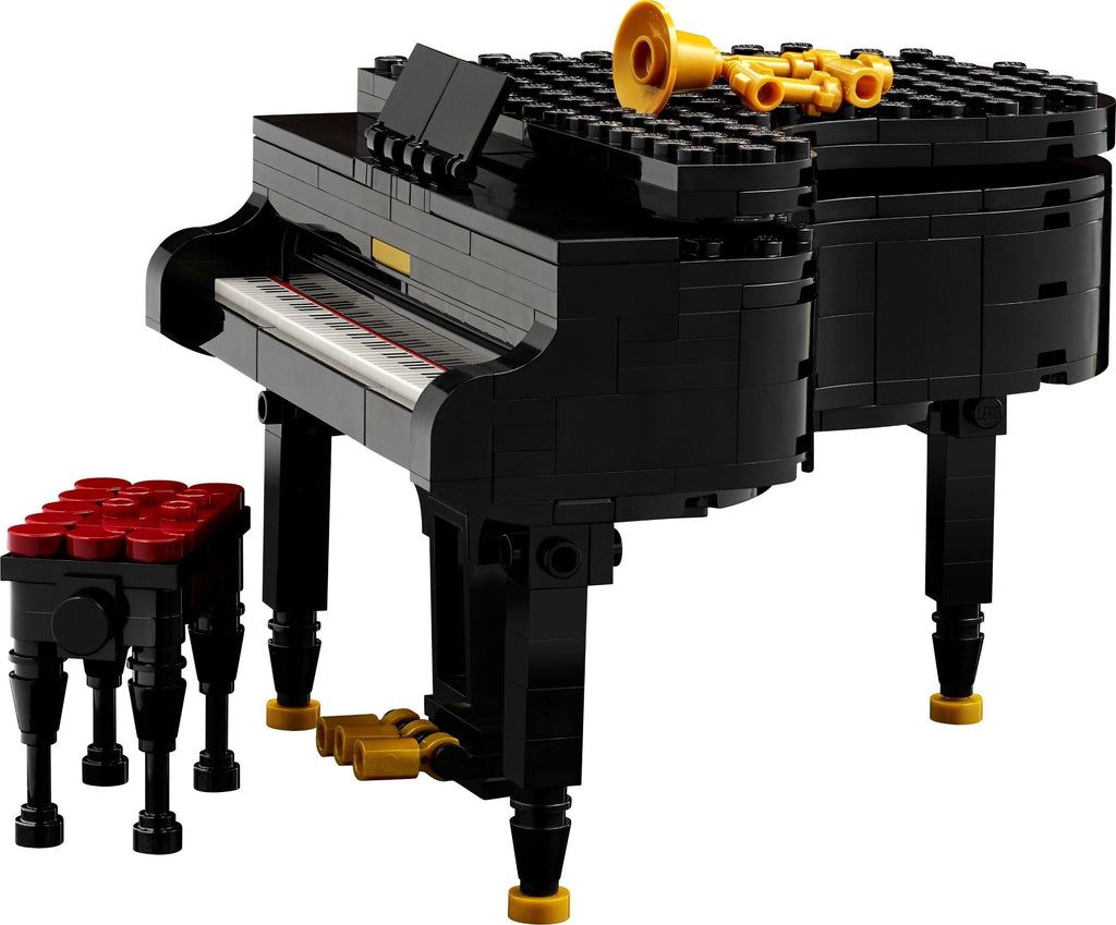 LEGO model of a grand piano with a stool on a white background