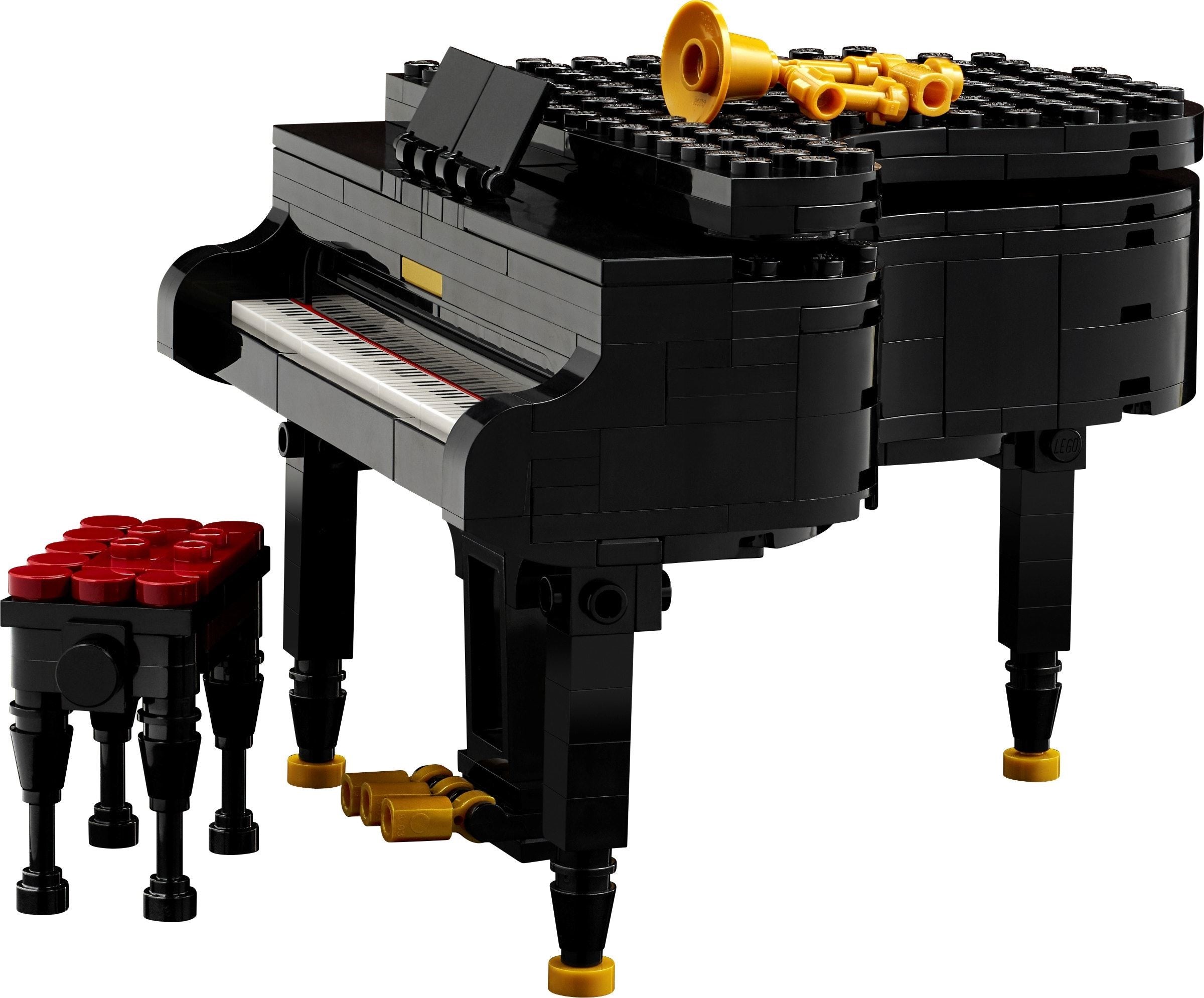 LEGO model of a grand piano with a stool on a white background