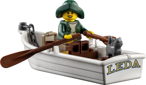 LEGO figure in a boat with a cat, holding a paddle, on a white background.