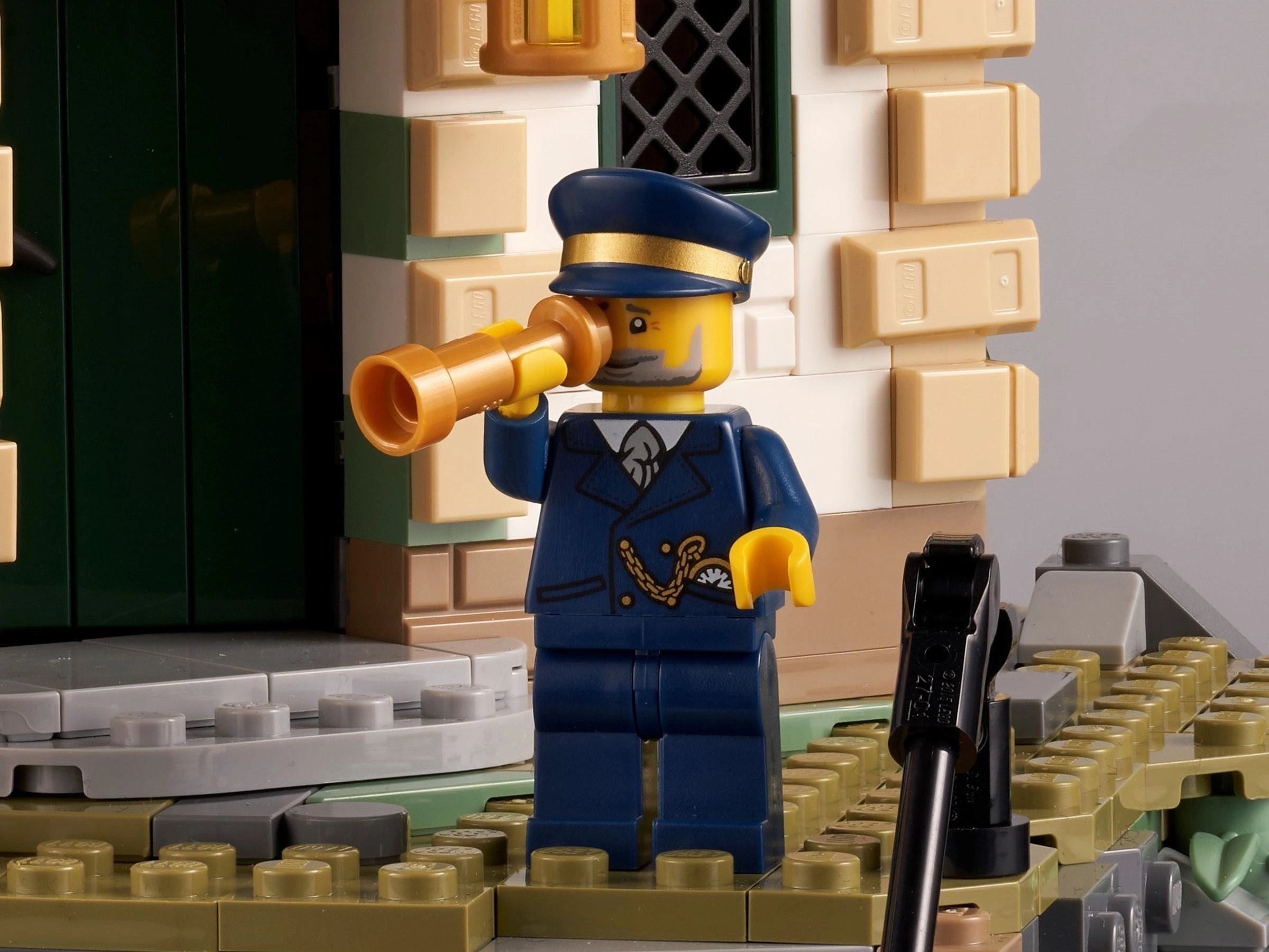 LEGO figure of a captain with binoculars on a detailed LEGO set