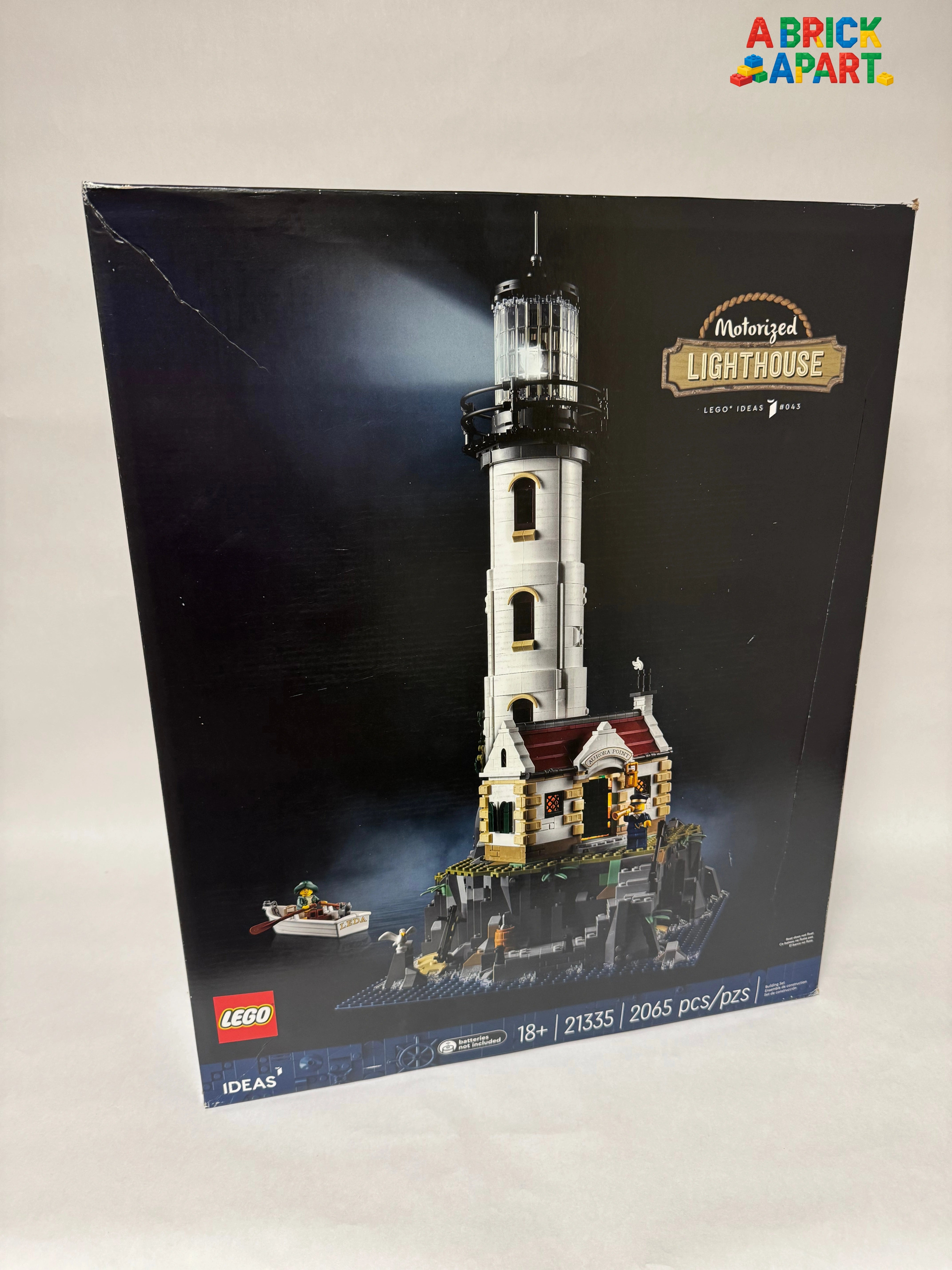 LEGO lighthouse set packaging on a light gray background