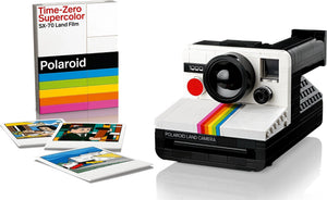 Polaroid camera with instant photos and packaging on a white background