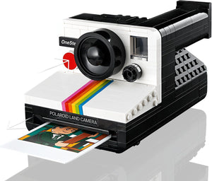 Polaroid Land Camera model with a printed photo on a white background
