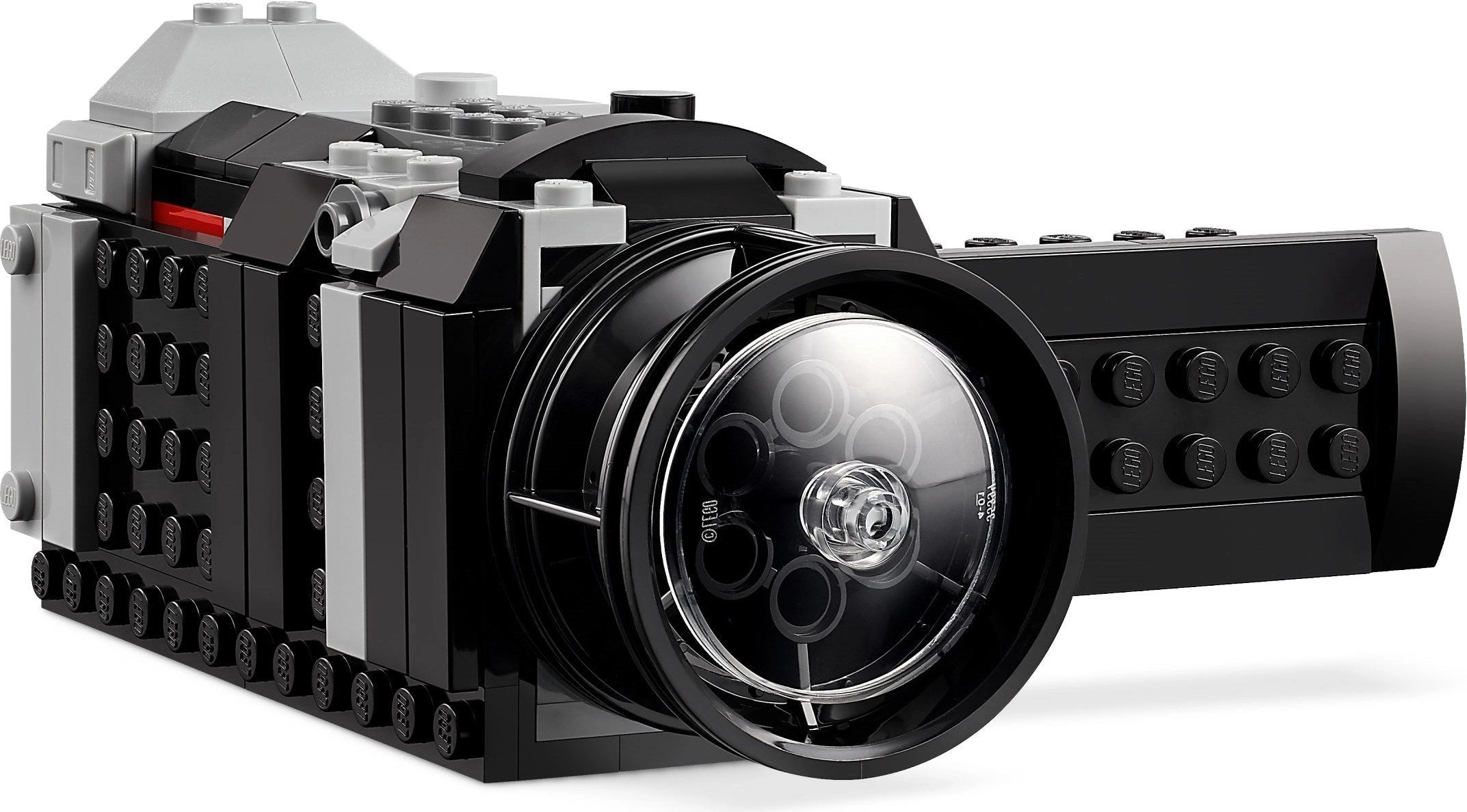 Toy camera made of interlocking bricks on a white background
