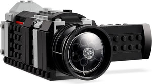 Toy camera made of interlocking bricks on a white background