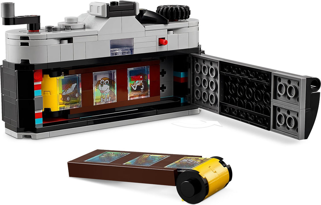 LEGO set with a camera model and open display case on a white background