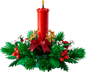 Red candle with green wreath and decorative elements on a white background