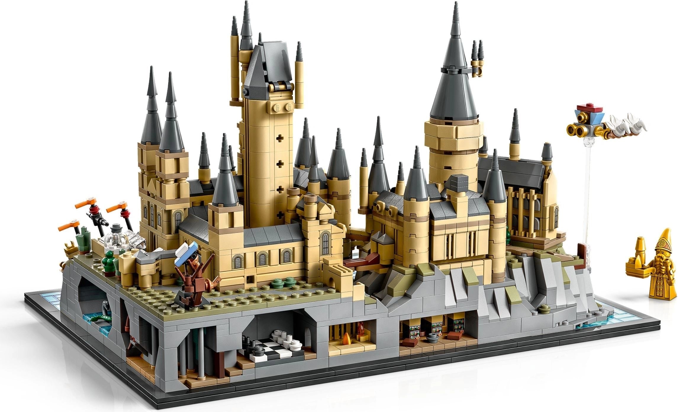Detailed LEGO model of a castle with multiple towers and structures on a white background