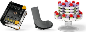 Two mechanical parts and a colorful cake-shaped object on a white background
