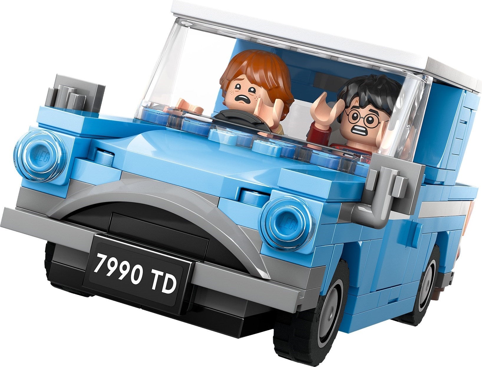 Toy car model with two figures inside, resembling a classic vehicle, on a white background.