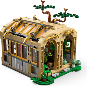 LEGO model of a greenhouse with detailed architecture and plants on a white background