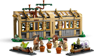 LEGO set with a building, characters, and plants on a white background