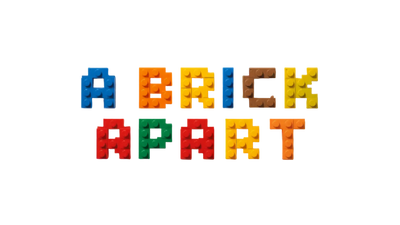 Colorful building blocks spelling 'A Brick Apart' on a textured surface.