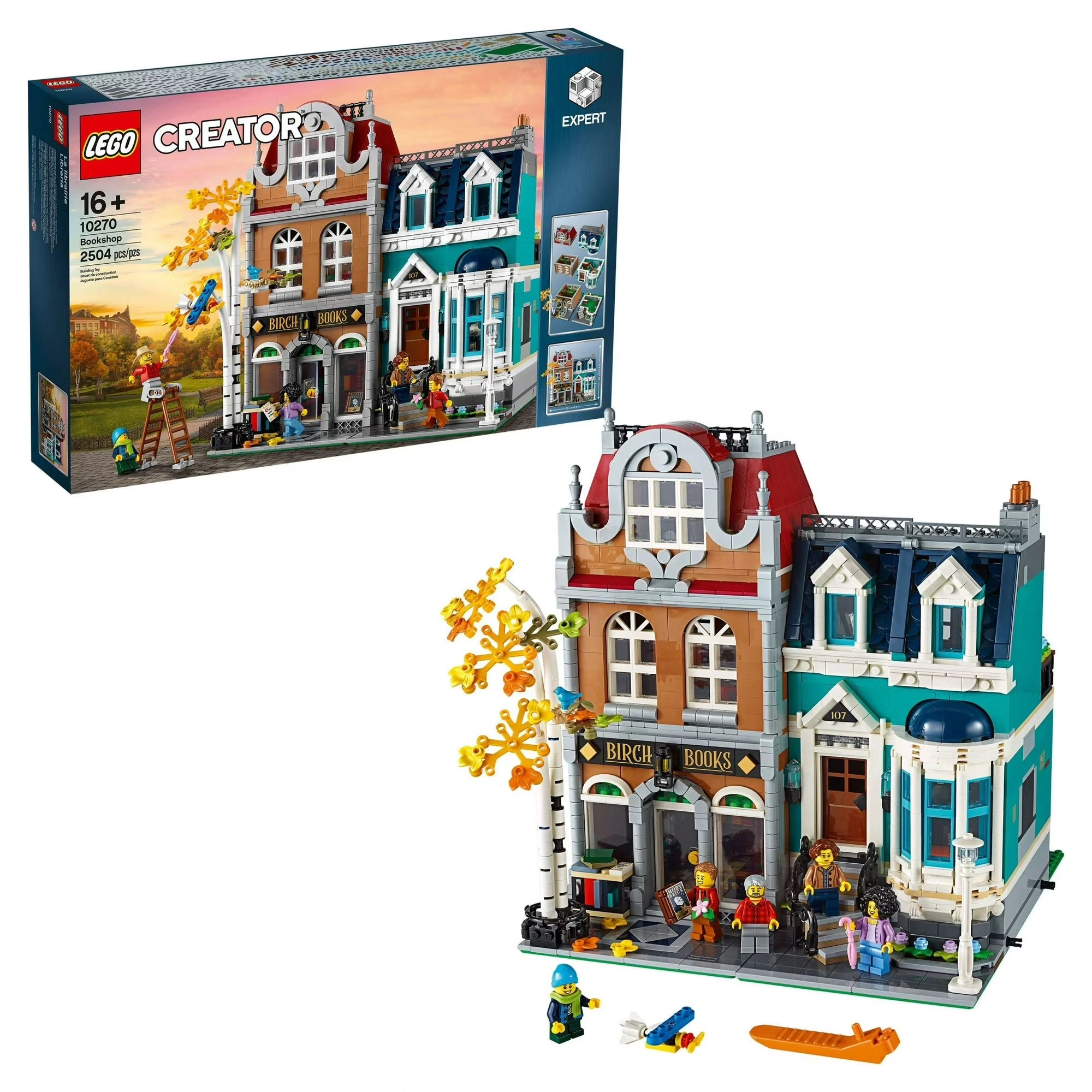 LEGO Creator Expert set with detailed buildings and figures, including a bookshop, in front of its packaging.