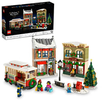 LEGO holiday town street set with buildings, a trolley, and people on a white background